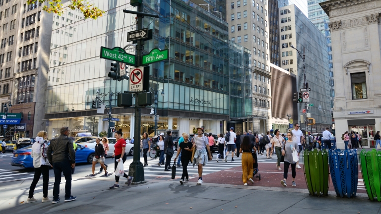 People crossing the intersection of 42nd Street and 5th avenue in Manhattan, NYC.